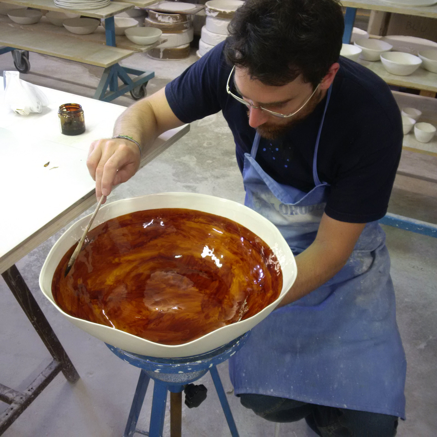 artisans making and hand-painting a porcelain bowl