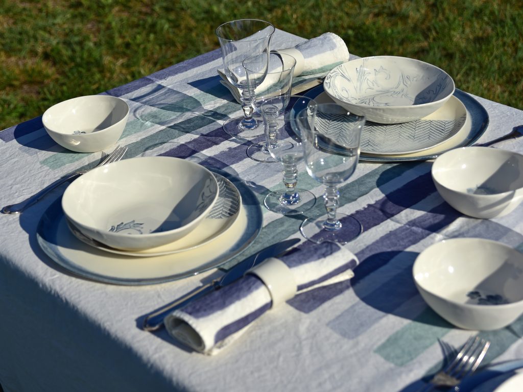 linen table setting with glass and ceramic tableware
