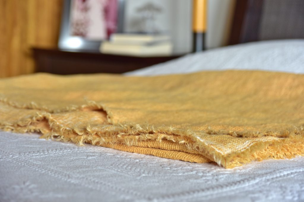 Waffle Throw - Hand-painted Linen Throw - Mustard - Throw draped over bed