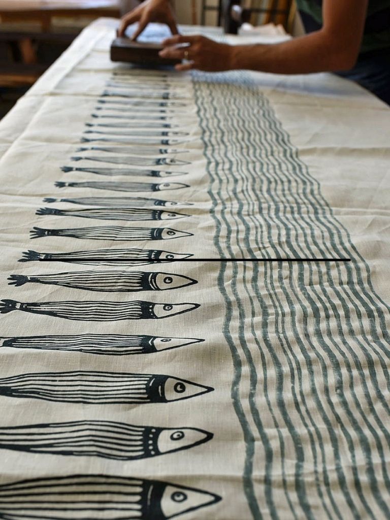 Linen tablecloth in the process of being block-printed to create a panarea design
