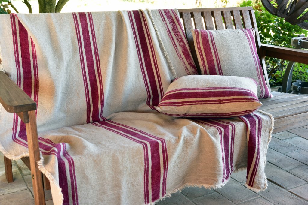 hemp throw - hemp linen throw - 'Roma' - Image displays the throw draped over outdoor bench with accompanying hemp cushions