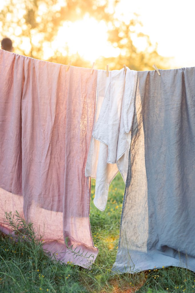 Linen fabrics hanging on washing line - one of the common misconceptions about linen is that is difficult to care for. This is simply not true!