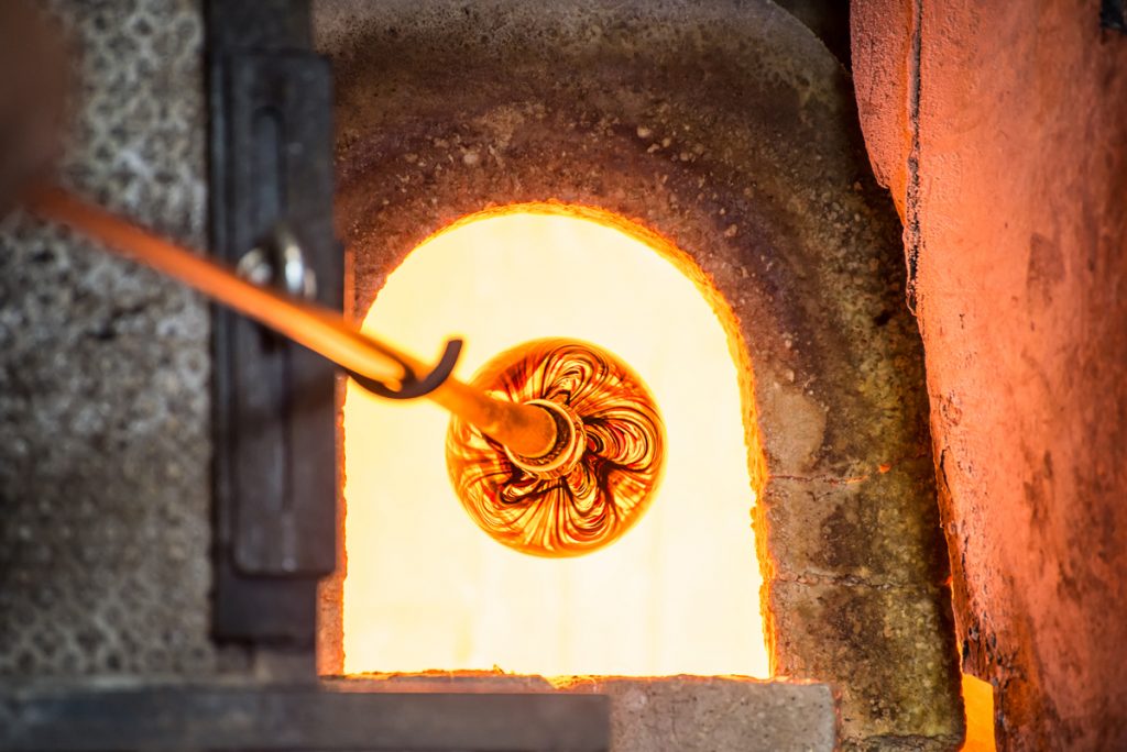 Murano glass is place in kiln as part of the process of manipulating the glass