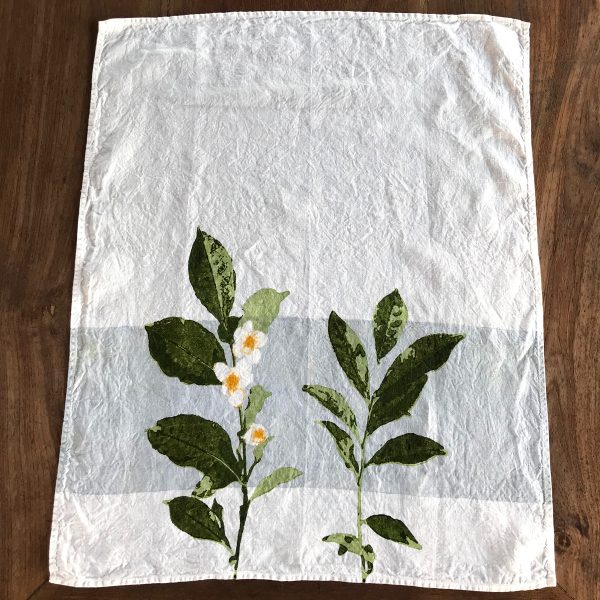 Shot from above of the Camellia organic linen tea towel with band.