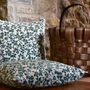 vintage cushion cover - vintage hemp linen - two cushions sitting on wooden floor beside wicker basket