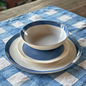 Limoges porcelain dinner set blue displayed on a linen checked placemat