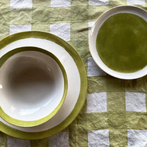 hand-painted porcelain dinnerware set green on a checked placemat