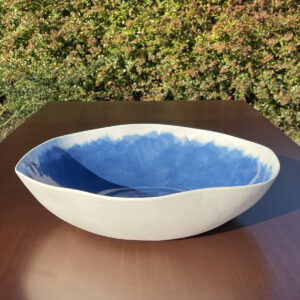 Hand painted blue porcelain serving bowl on on a wooden table