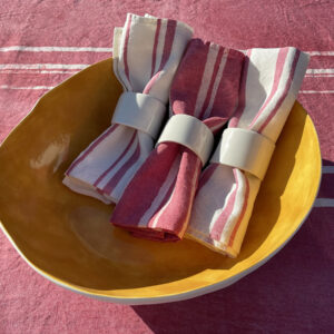 Limoges porcelain bowl in ochre colour with linen napkins inside