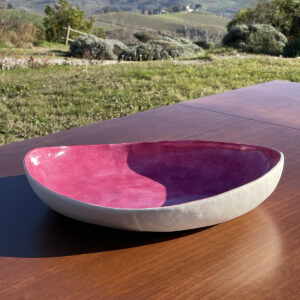 Handmade porcelain oval serving bowl on a table in the open air