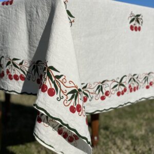 corner of an hand-printed linen tablecloth cherry design