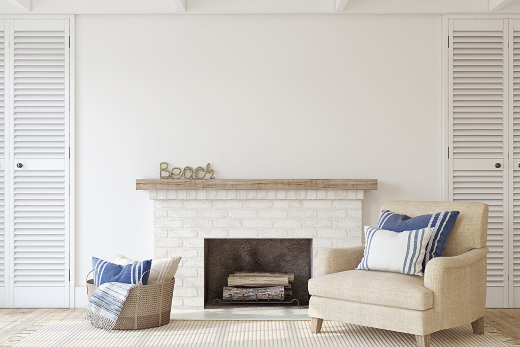 blue striped cushions on a armchair besides a fireplace