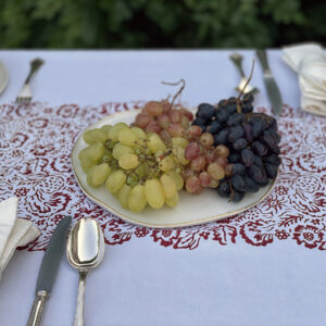 Italian linen tablecloth with plates full of grapes