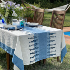 Maritime and coastal linen tablecloth laid outside by the pool