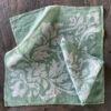 teal linen napkins laid on wooden board