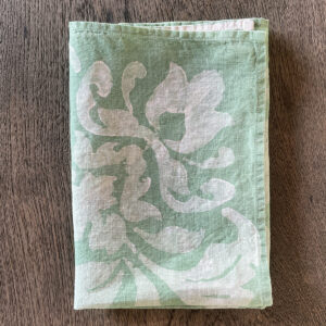 folded linen napkin in teal colour