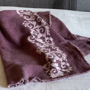 linen throw in plum colour with hand-printed white foliage motif printed