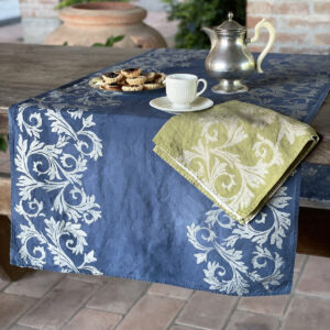 hand-printed blue runner laid on wooden table with vintage coffe pot and cup on top