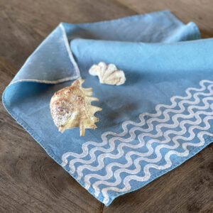 blue linen napkins laid not a wooden table with shells