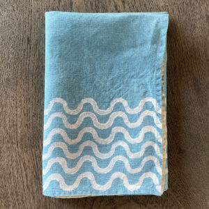 folded linen napkin withs waves motif perfect for a beach house