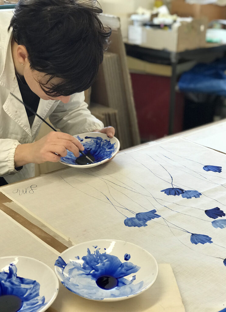 hand-painting linen tea towel with blue flowers