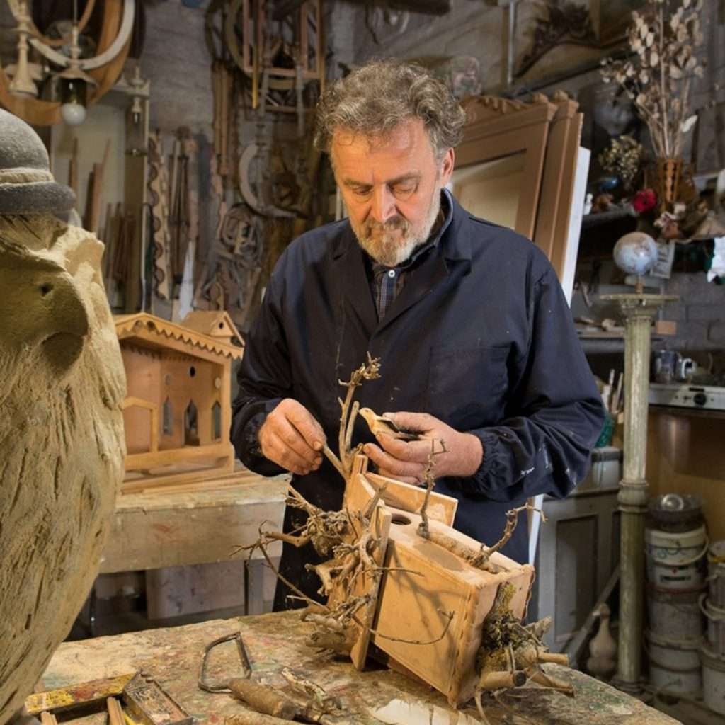 Italian artisan hand-crafting a wooden bird house