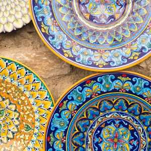 Italian hand-painted ceramic plates hanged on a wall