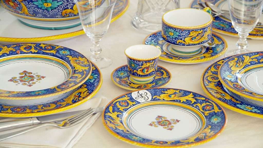 Italian hand-painted ceramic table setting in rich blue and yellow tones
