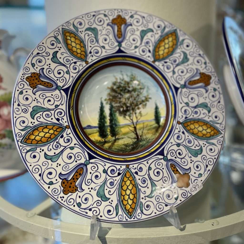 Tuscan hand-painted ceramic plates featuring the countryside landscape design