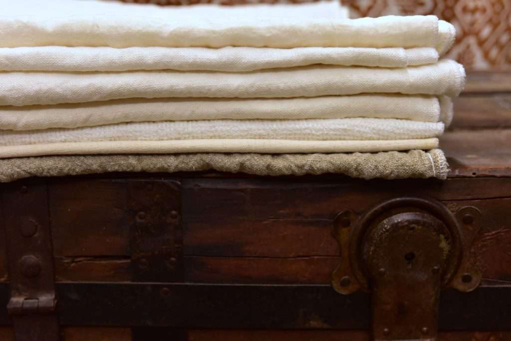 European linen towels laid on a wooden sideboard