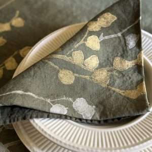Luxury linen napkin in dark-olive green with gold and silver floral motif