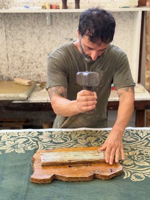 Artisan making a wood-block printed linen tablecloth, perfect handmade gift