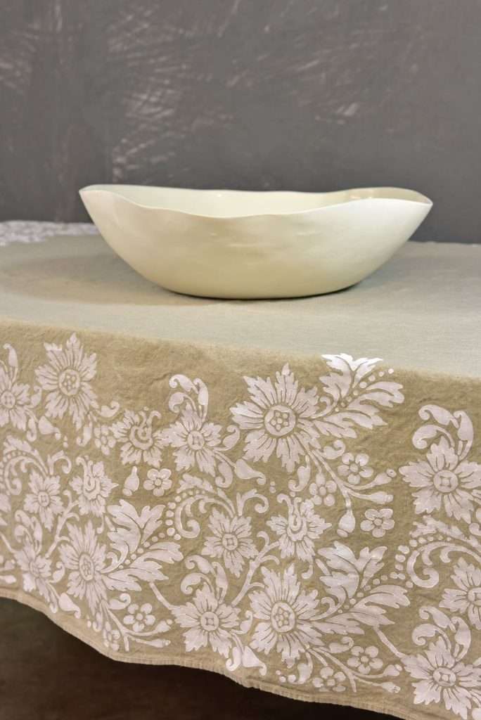 Vintage hemp linen tablecloth with a modern porcelain bowl on top