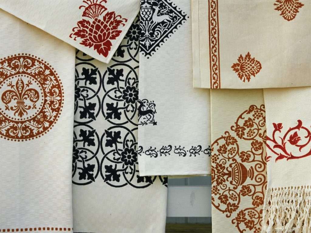 vintage table linens featuring wood-block printed motifs inspired by the renaissance era
