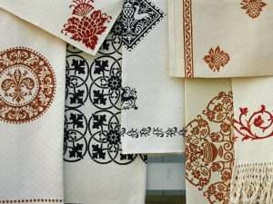 vintage table linens featuring wood-block printed motifs inspired by the renaissance era