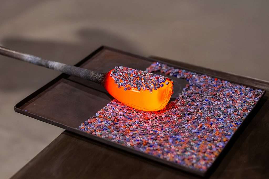Molten glass being crafted using the millefiori technique