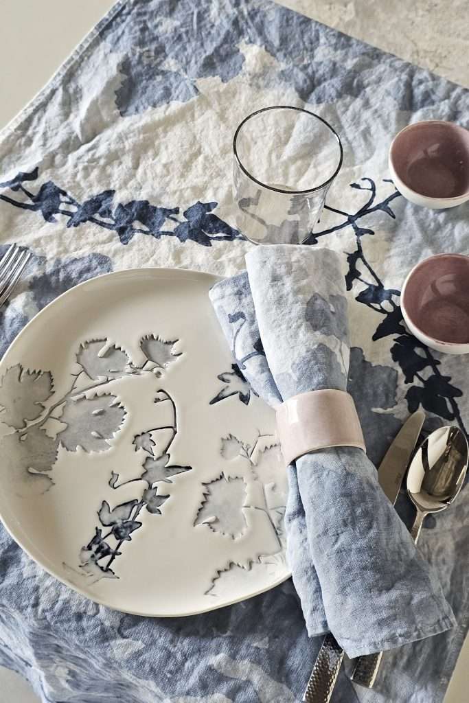 Italian table setting with linen tablecloth and ceramics