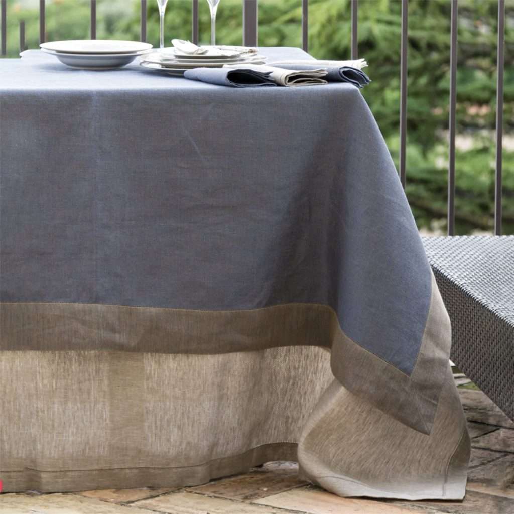 Linen tablecloth with border design laid on a table in the terrace