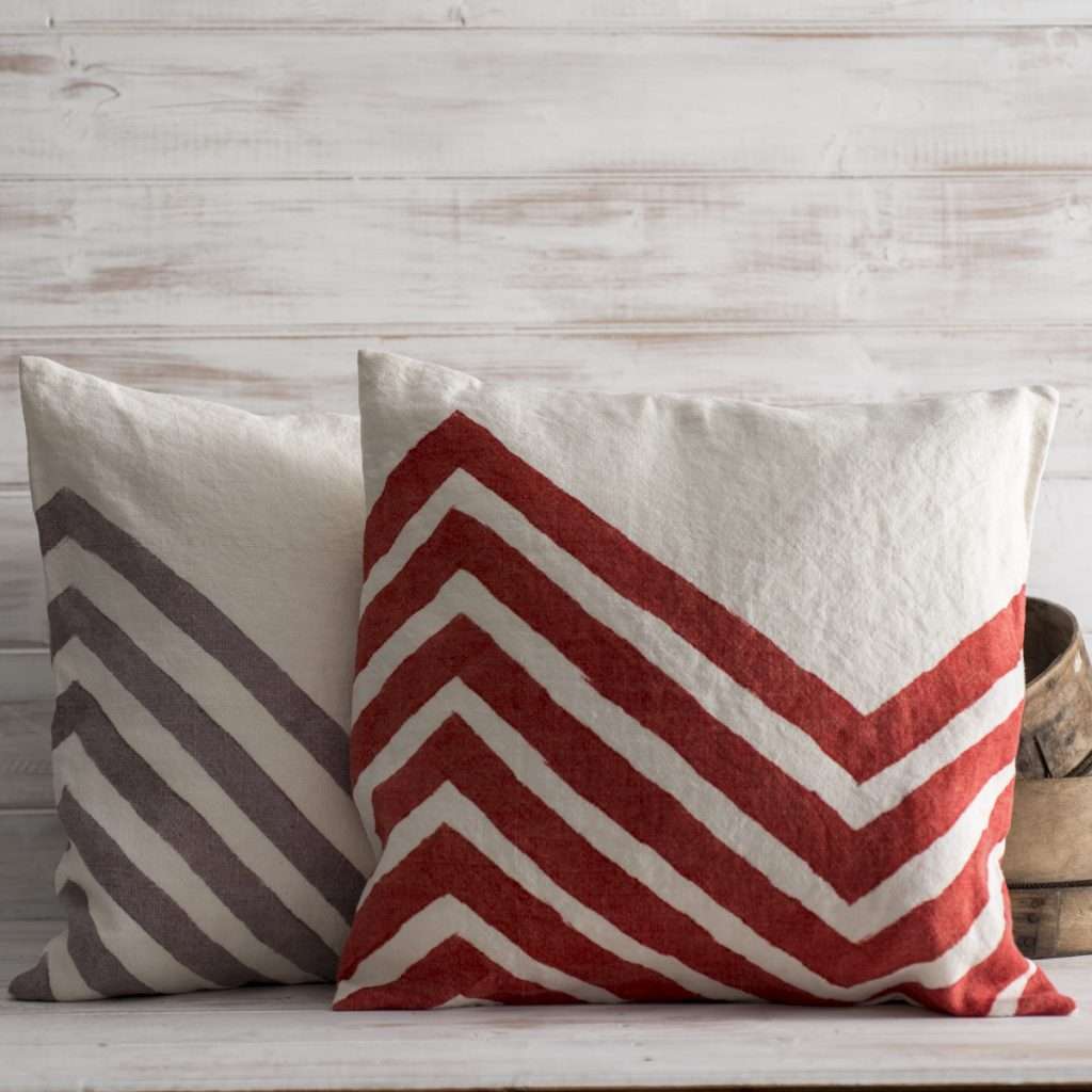 Chevron-painted-cushion-in-red-and-brown