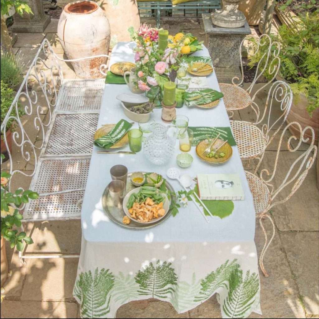 Linen tablecloth in fern design laid on a table in alfresco setting