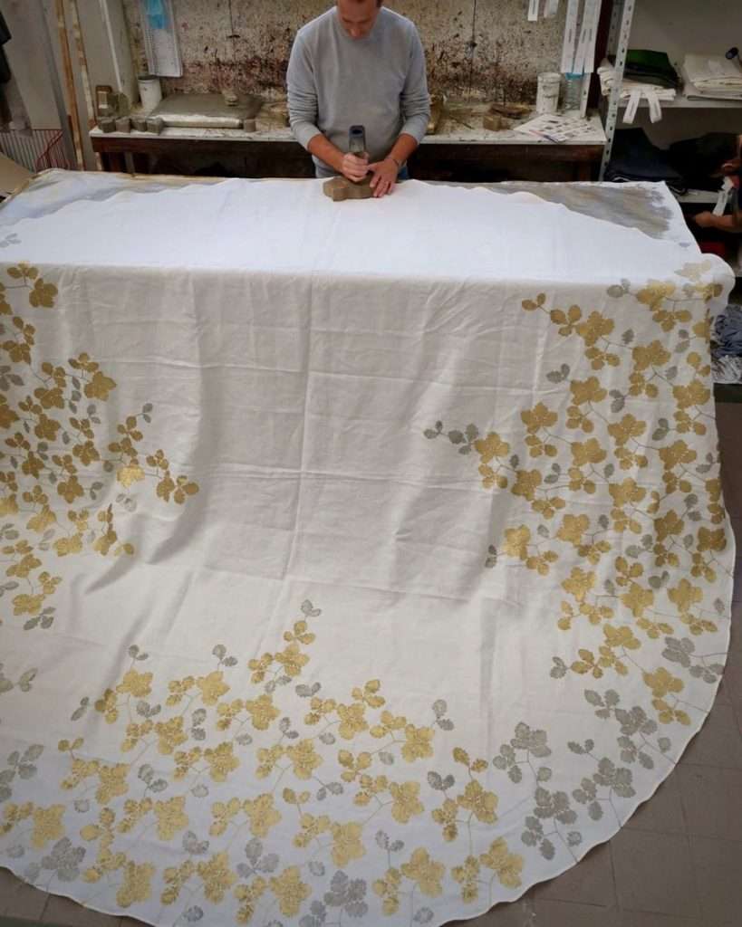 hand-printing a large round linen tablecloth in oak leaves design