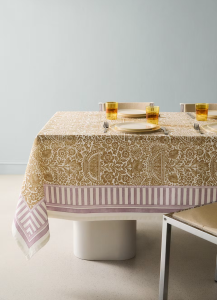 A minimalist dining room featuring a tablecloth in traditional design