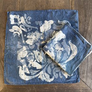 blue linen napkins laid onto a wooden table