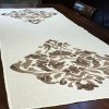 Handcrafted white linen table runner bock-prints with damask motif in brown colour