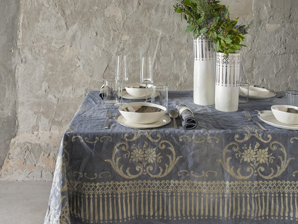 Opulent linen tablecloth hand-painted a block printed in a classic motif in gold