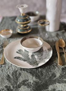 Christmas table dress with handmade table linens and tableware in green fir tree design