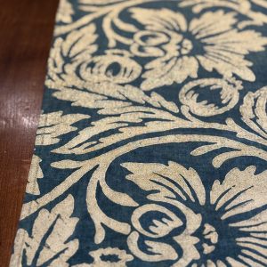 Gold pomegranate motif block-printed onto a green teal linen table runner
