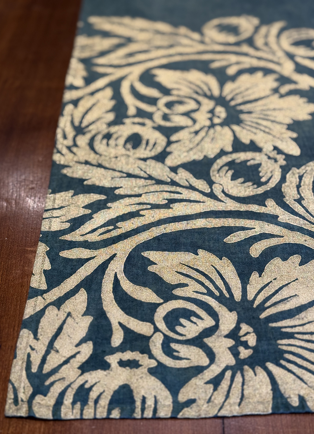 Gold pomegranate motif block-printed onto a green teal linen table runner